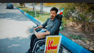 سیگار فروش ویلچری که پرچمدار شرافت است